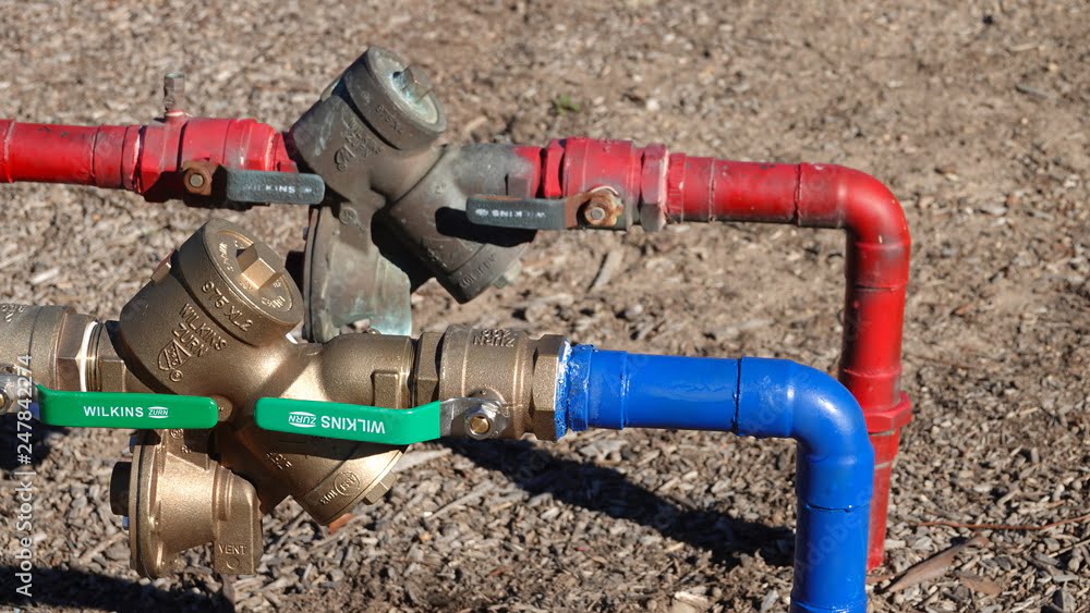 Red and blue water lines with backflow preventer